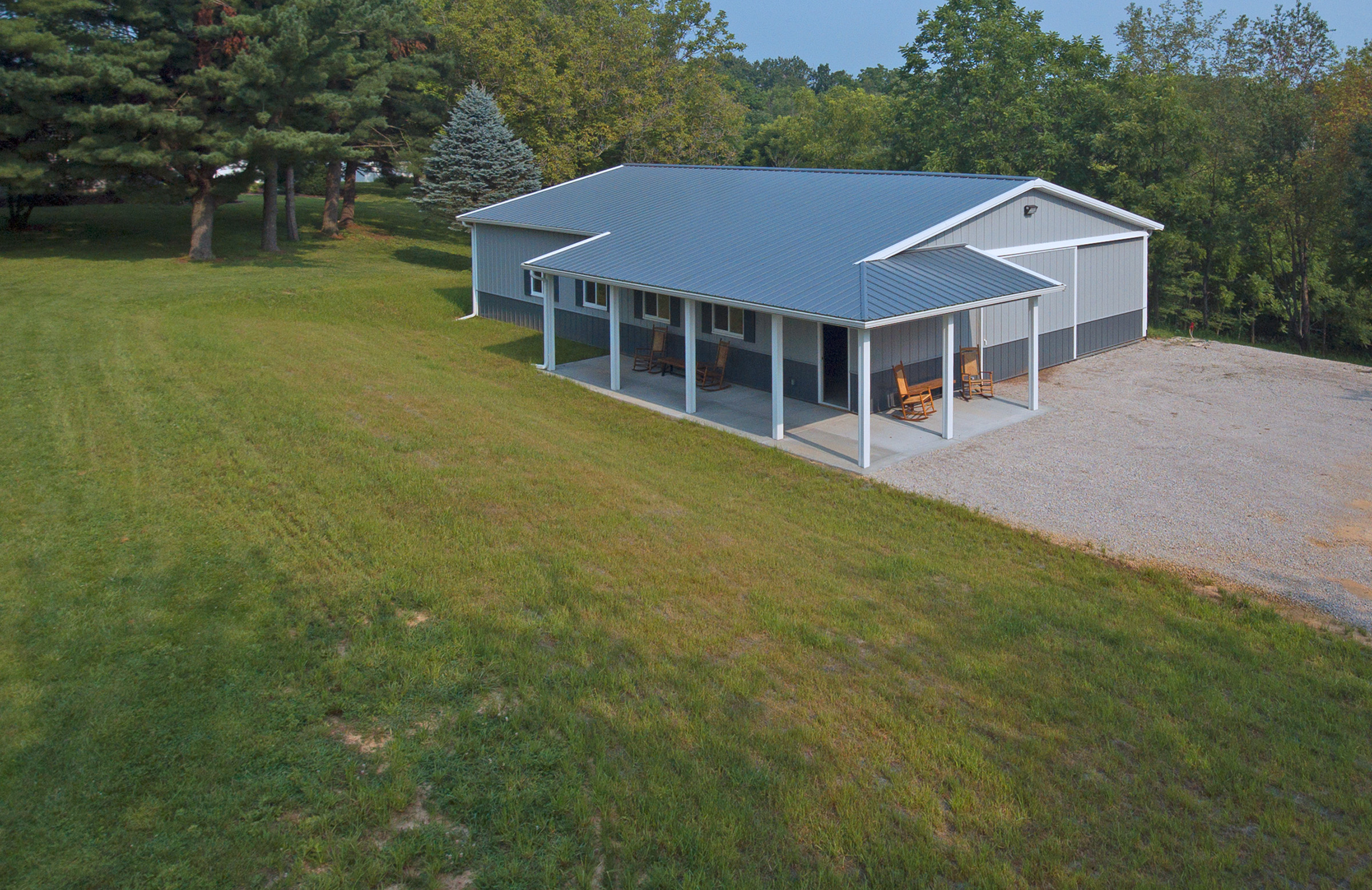 large field containing a post frame suburban building